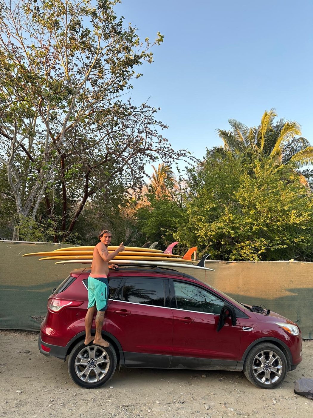 Carlos loading longboards onto the roof of his car