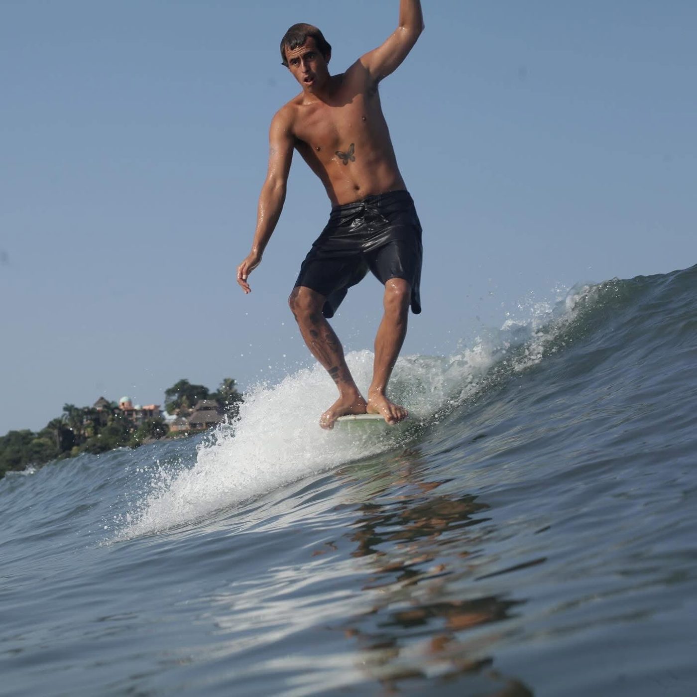 Carlos trimming down the line on a longboard