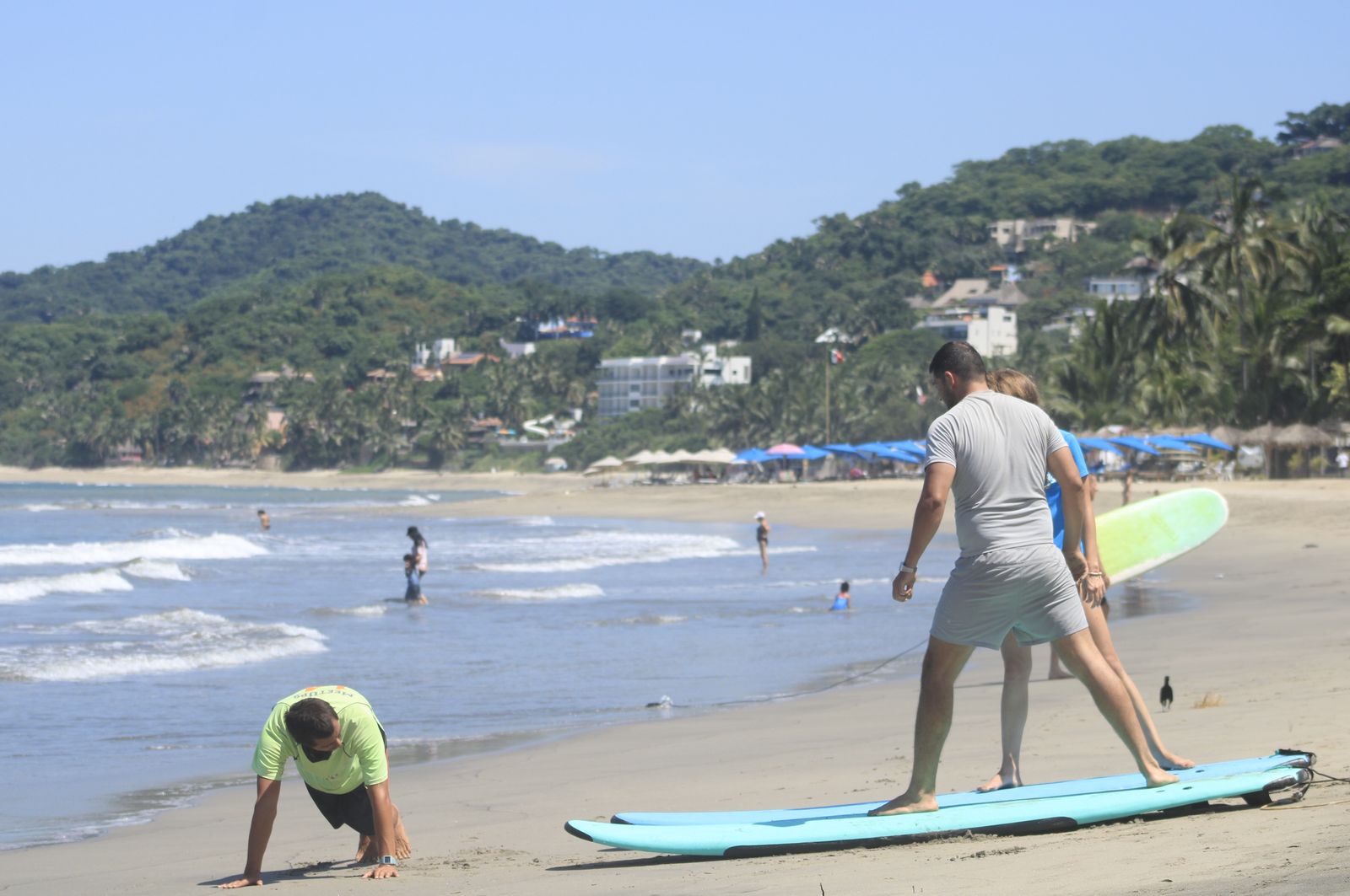 Carlos demonstrating the pop-up while a student practices on a board