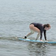 A student popping up on her first wave