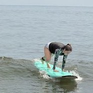 A student getting to her feet on a soft-top